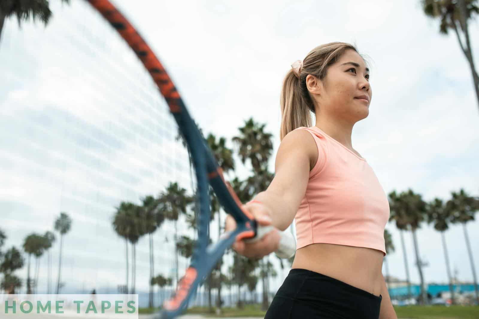 A Woman in Pink Tank Top Holding a Tennis Racket